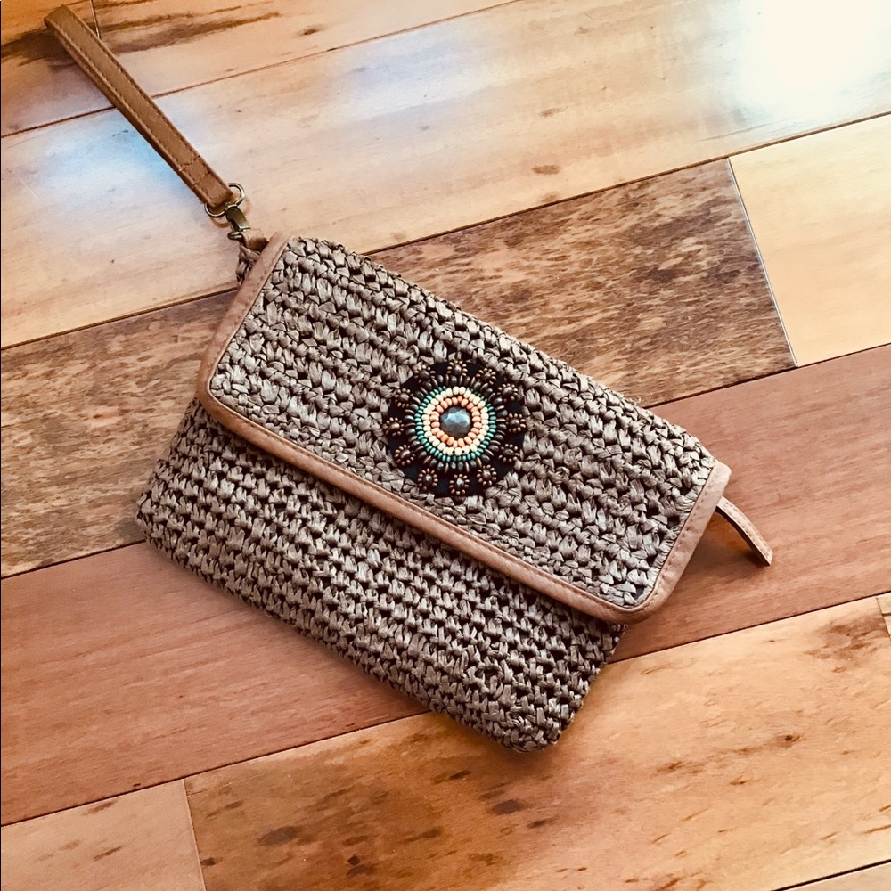 Cato straw wristlet with beading detail.